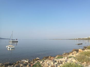 Sailboat on sea against clear sky