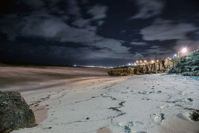 Scenic view of beach against sky at night