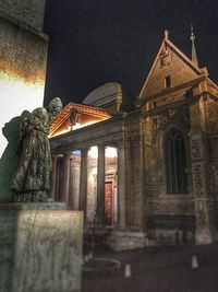 Statue of illuminated temple at night