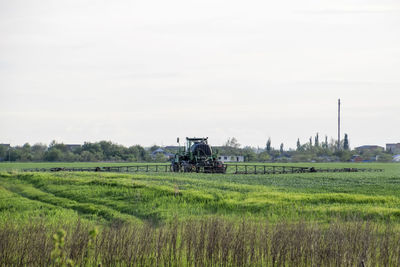 Scenic view of agricultural field against sky