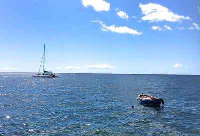 Ship sailing on sea against sky