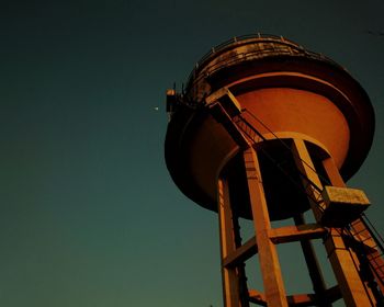 Low angle view of old tower against clear sky