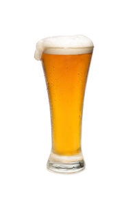 Close-up of beer glass against white background