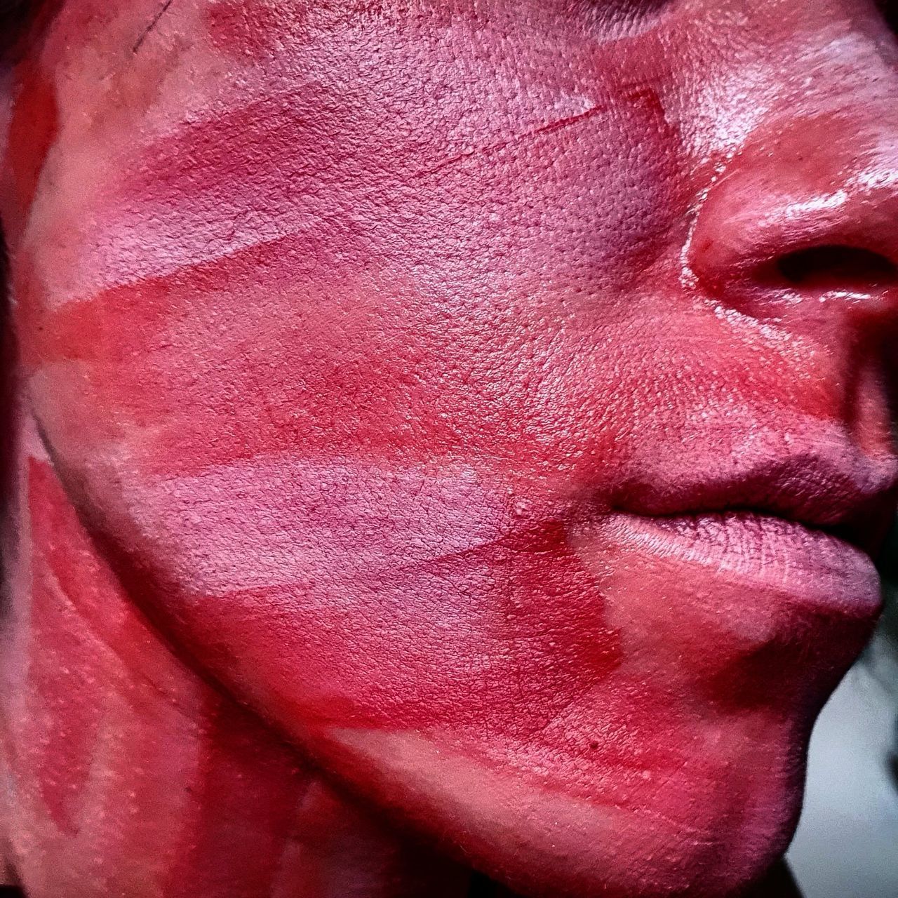 CLOSE-UP PORTRAIT OF WOMAN WITH PINK RED FACE