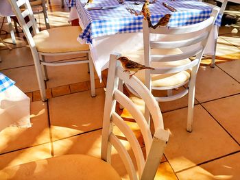 Low section of people sitting on chair in restaurant