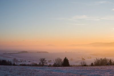 Scenic view of field against sky during sunset