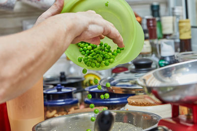 Midsection of person preparing food in kitchen at home