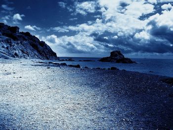 Scenic view of sea against cloudy sky