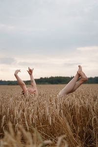 Full length of woman lying on field against sky