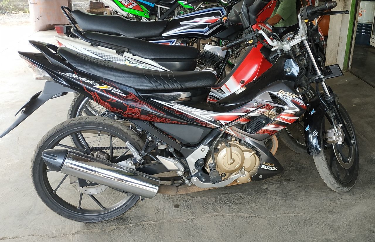 HIGH ANGLE VIEW OF BICYCLES PARKED ON ROAD