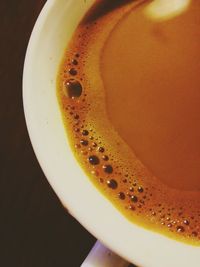 Close-up of coffee cup against black background