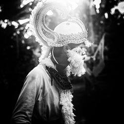 Side view of boy wearing costume standing outdoors