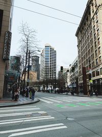 View of city street and buildings against sky