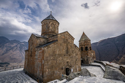 Historic building against sky, gergeti