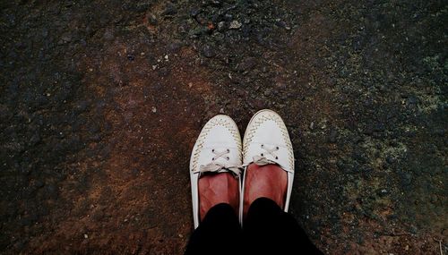 Low section of woman standing on street