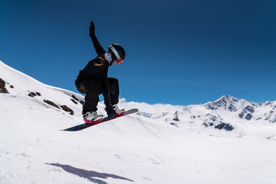 Low angle view of man skiing on snow covered landscape