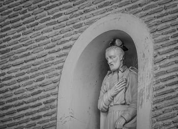 Statue of buddha against wall