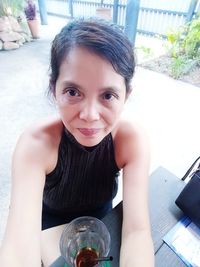 Portrait of smiling girl with drink on table
