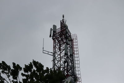 Low angle view of communications tower against sky