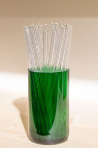 Close-up of straws in glass on table