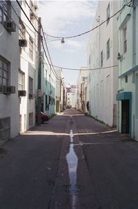 Empty road with buildings in background