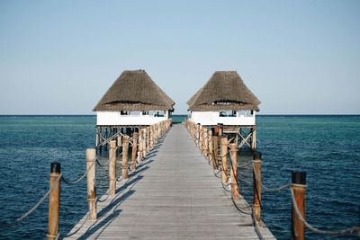 Pier over sea against clear sky