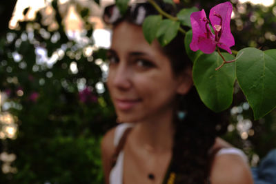 Close-up of young woman with flower tree