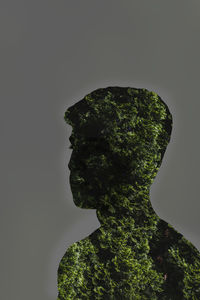 Close-up of silhouette statue against sky