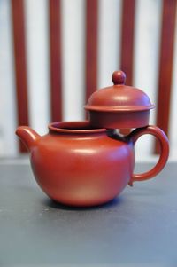 Close-up of teapot and lid on table