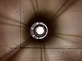 Low angle view of light bulb hanging from ceiling