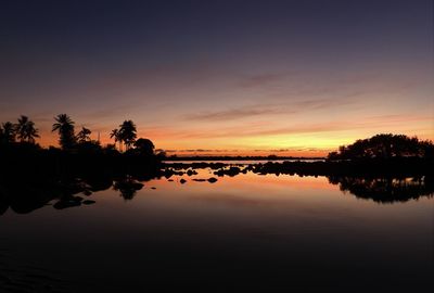 Scenic view of lake against orange sky