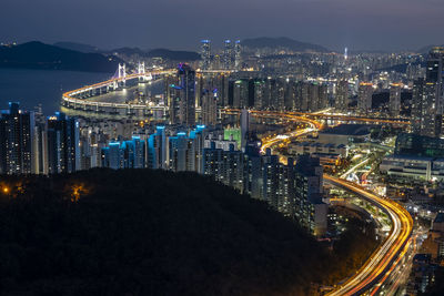 High angle view of city lit up at night