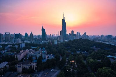 View of buildings in city at sunset