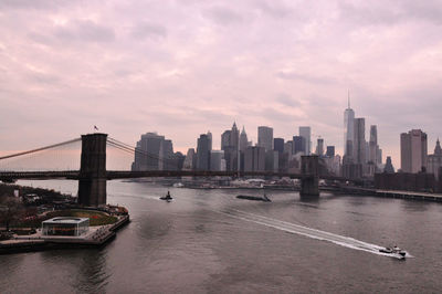 View of suspension bridge with city in background