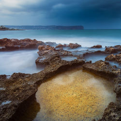 Scenic view of sea against cloudy sky