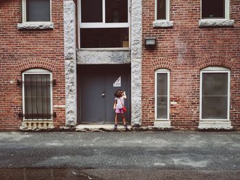 Woman looking through window