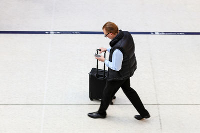 Full length of man holding umbrella