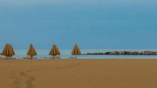 View of beach against clear blue sky