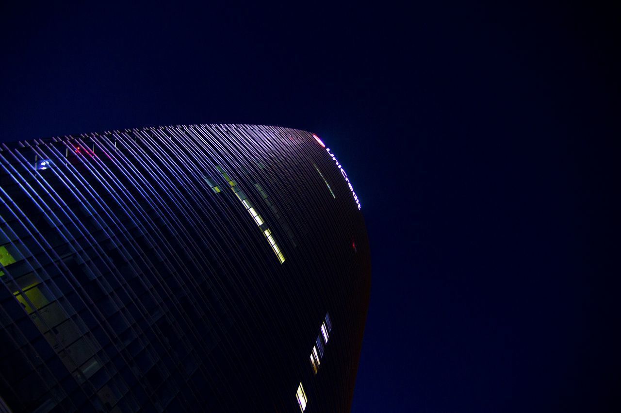 LOW ANGLE VIEW OF ILLUMINATED FERRIS WHEEL AGAINST SKY AT NIGHT