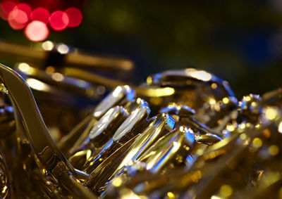 Close-up of a saxophone in front of a christmas tree.