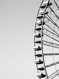 Low angle view of ferris wheel against clear sky