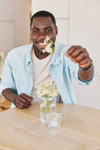 Midsection of woman having food on table