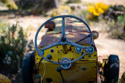 Close-up of rusty car on field