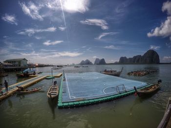 Boats moored in sea against sky