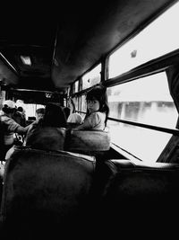Rear view of people sitting in bus