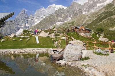 Rear view of people walking on mountain