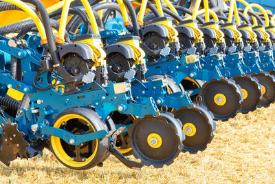 A fragment of the wheel mechanism of a multi-row seeder against the background of the stubble