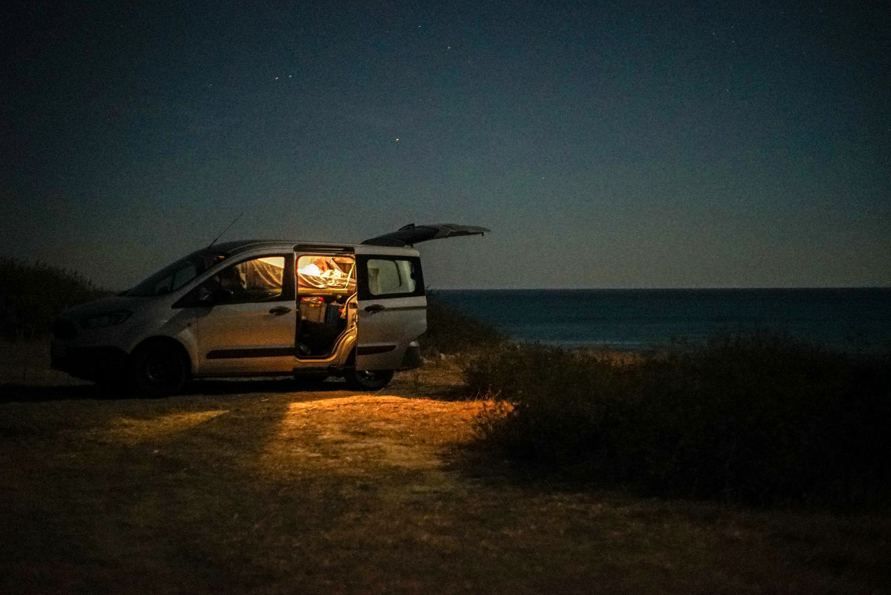 VIEW OF CAR ON ROAD AT NIGHT