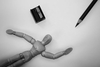 High angle view of person hand on table against white background