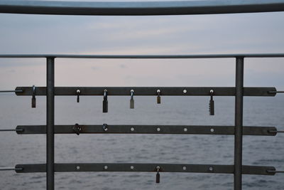 Close-up of railing against sky